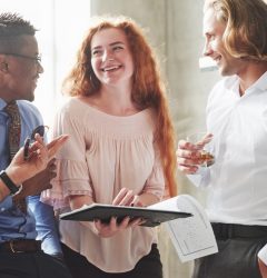 Office workers smiling and talking about their new project.